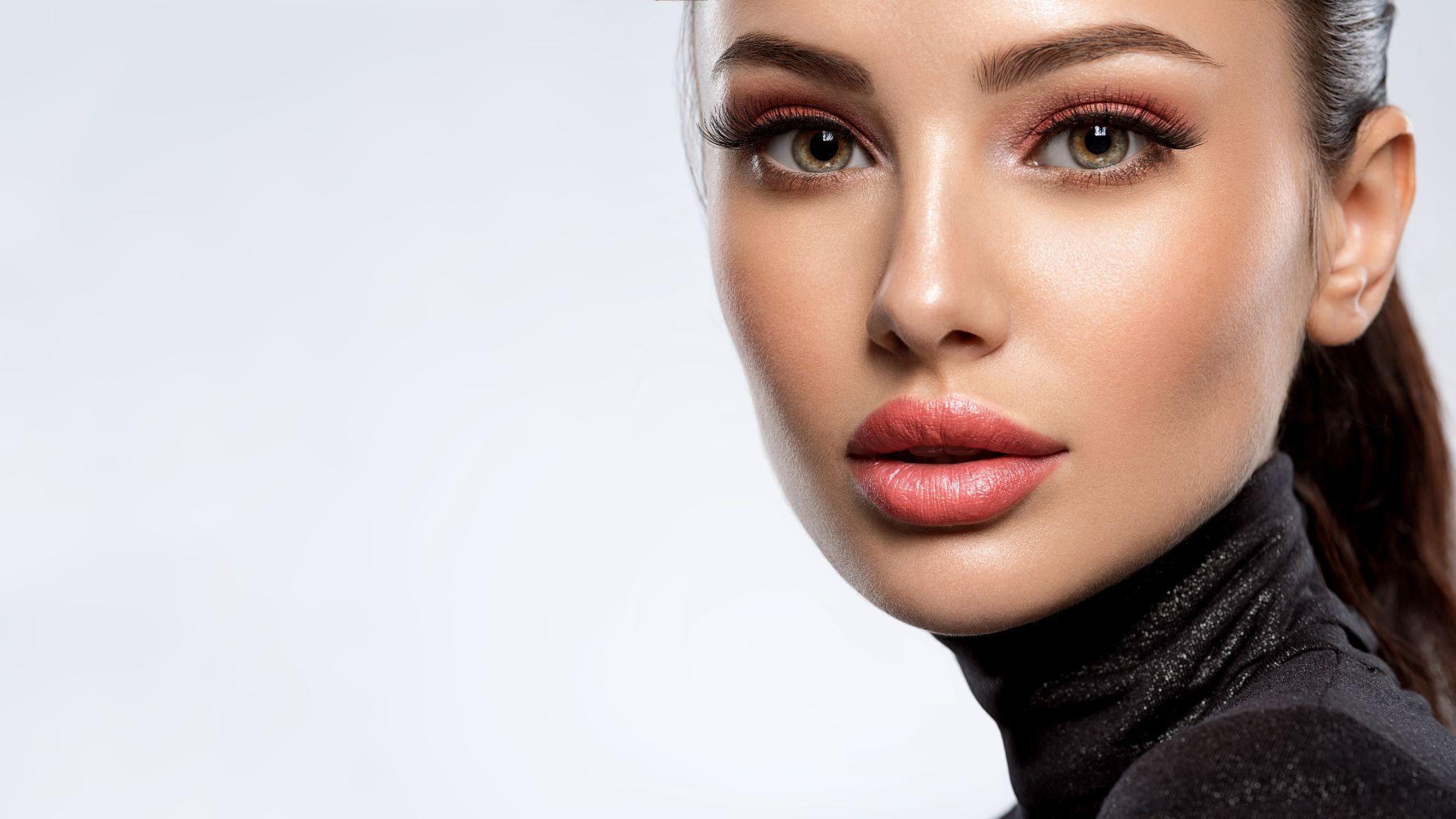 Portrait of beautiful young woman with bright pink makeup